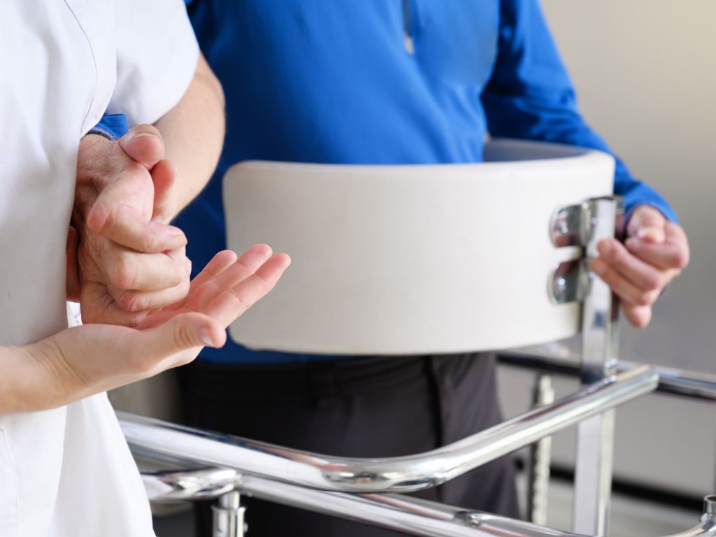 Caregiver assisting patient with amyotrophic lateral sclerosis