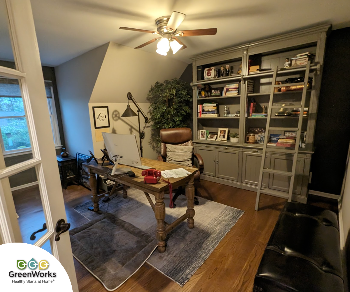 A well-organized home office with a desk, a bookshelf, and a fan for comfort and airflow. Photo by victor j. Coppola with greenworks environmental, llc